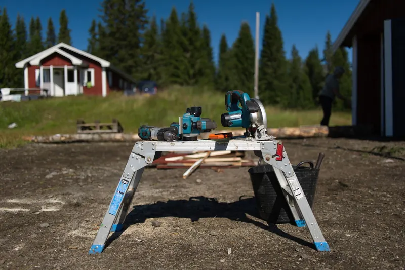 Outdoor setup with power tools for construction work in a summer setting