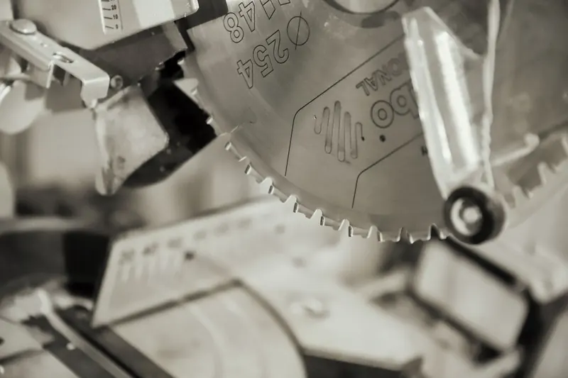 Detailed view of a circular saw blade in an industrial workshop, showcasing precision and craftsmanship