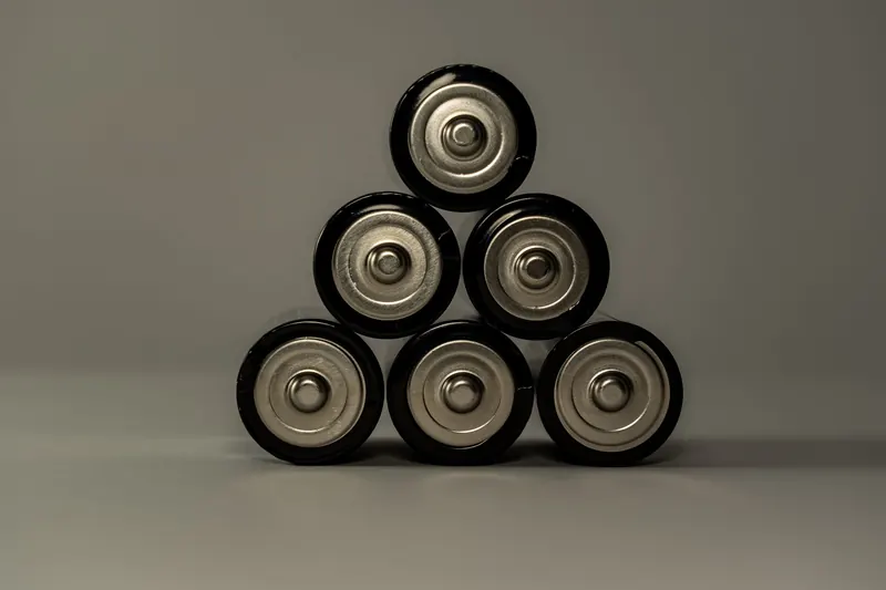 Metallic AA batteries stacked in a pyramid shape, symbolizing power and energy storage