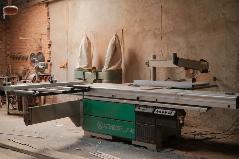 Cozy woodworking workshop featuring a professional Altendorf F45 sliding table saw