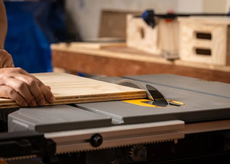 Craftsman working with a circular saw, expertly cutting plywood for woodworking projects